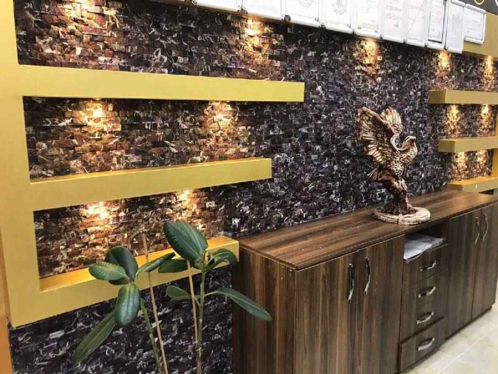 Dark natural split stone accent wall design for TV lounge interior in Pakistan