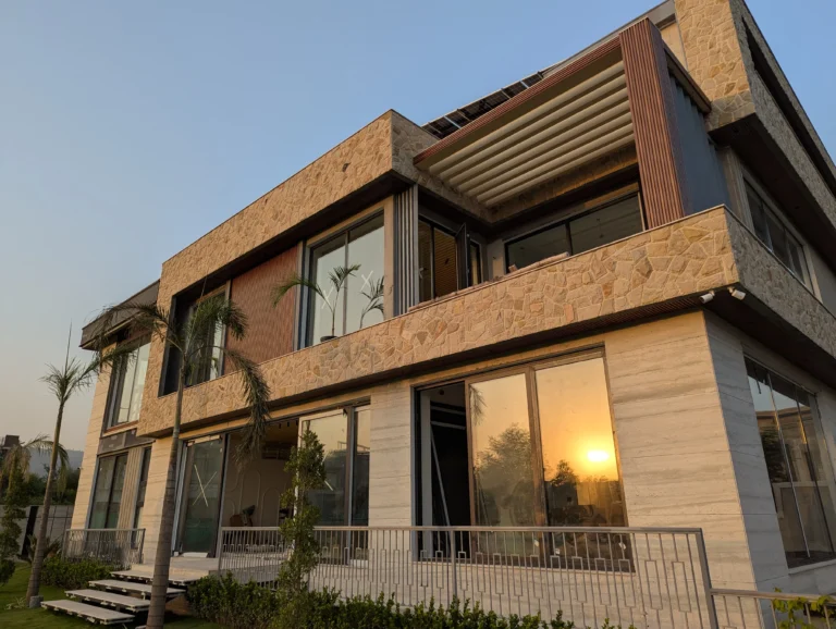 Front elevation stone designs Pakistan: modern home facade with natural stone and warm wood accents